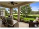 Relaxing screened patio with comfortable seating, overlooking a well-manicured lawn and a scenic golf course at 17727 Garsalaso Cir, Brooksville, FL 34604