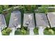 Aerial view of three homes with gray roofs and a yellow car parked in the driveway of one of the homes at 17843 Garsalaso Cir, Brooksville, FL 34604