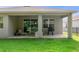 Backyard featuring a covered patio with a grill and seating at 17843 Garsalaso Cir, Brooksville, FL 34604