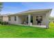 Lawn featuring a covered patio with a grill and seating at 17843 Garsalaso Cir, Brooksville, FL 34604