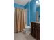 Bathroom featuring a shower with tan curtain and granite vanity at 17843 Garsalaso Cir, Brooksville, FL 34604