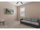 Bedroom with TV and gray couch at 17843 Garsalaso Cir, Brooksville, FL 34604