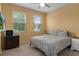 Bedroom with a comfortable bed and natural light streaming in through multiple windows overlooking neighborhood views at 17843 Garsalaso Cir, Brooksville, FL 34604