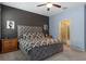 Comfortable bedroom boasting stylish gray accents, a plush bed, and warm lighting from bedside lamps at 17843 Garsalaso Cir, Brooksville, FL 34604