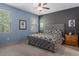 Spacious bedroom features neutral colored walls, a large bed with a padded headboard, and natural lighting at 17843 Garsalaso Cir, Brooksville, FL 34604