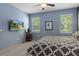 Inviting bedroom with large windows, neutral colored walls, and a cozy bed with decorative pillows at 17843 Garsalaso Cir, Brooksville, FL 34604