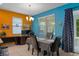 Dining area with large window, slider door, modern light fixture, and desk workstation at 17843 Garsalaso Cir, Brooksville, FL 34604