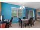 Bright dining room featuring a modern chandelier, a large window, and a table with seating for four at 17843 Garsalaso Cir, Brooksville, FL 34604
