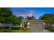 Charming single-Gathering home featuring a well-maintained lawn, mature trees, and neutral exterior paint at dusk at 17843 Garsalaso Cir, Brooksville, FL 34604