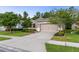 Charming single-Gathering home featuring a well-maintained lawn, mature trees, and neutral exterior paint at 17843 Garsalaso Cir, Brooksville, FL 34604