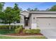 Charming single-Gathering home featuring a well-maintained lawn, mature trees, and neutral exterior paint at 17843 Garsalaso Cir, Brooksville, FL 34604