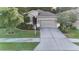 Well-maintained lawn and landscaping highlight this home's inviting facade and attached two car garage at 17843 Garsalaso Cir, Brooksville, FL 34604