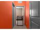 Hallway view with safety gate and orange accent wall at 17843 Garsalaso Cir, Brooksville, FL 34604