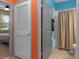 Hallway offering convenient access to a full bathroom with shower/tub combo, and a sunlit bedroom at 17843 Garsalaso Cir, Brooksville, FL 34604
