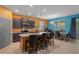Open kitchen and dining area with granite island, dining table, and modern decor at 17843 Garsalaso Cir, Brooksville, FL 34604