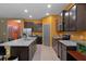 Spacious kitchen featuring stainless steel appliances, granite countertops, and a large island at 17843 Garsalaso Cir, Brooksville, FL 34604