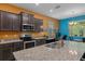 Well-equipped kitchen with granite countertops, stainless steel appliances, and eat-in dining area at 17843 Garsalaso Cir, Brooksville, FL 34604