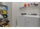 Laundry room area with shelves and white washer and dryer at 17843 Garsalaso Cir, Brooksville, FL 34604