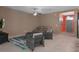 Cozy living room featuring neutral walls, tile flooring, and comfortable seating arrangement at 17843 Garsalaso Cir, Brooksville, FL 34604