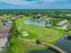 An aerial view of a golf course and surrounding homes in a well-maintained community at 18845 Fairway Green Dr, Hudson, FL 34667