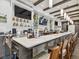 This is the bar with TV's, overhead lighting, and a long white countertop at 18845 Fairway Green Dr, Hudson, FL 34667