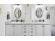 Bright bathroom features double sinks, storage, vanity, and tile floors at 18845 Fairway Green Dr, Hudson, FL 34667