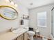 Bright bathroom with a golden framed mirror, neutral paint, and a vanity with sink at 18845 Fairway Green Dr, Hudson, FL 34667