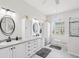 Bright bathroom features glass shower, storage, double vanity, and tile floors at 18845 Fairway Green Dr, Hudson, FL 34667