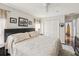 Comfortable bedroom featuring a queen bed, black furniture, ceiling fan, and hard wood floors at 18845 Fairway Green Dr, Hudson, FL 34667