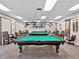 Billiard room featuring multiple pool tables with elegant overhead lighting at 18845 Fairway Green Dr, Hudson, FL 34667