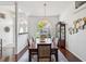Elegant dining room with a large table, chandelier, and large window at 18845 Fairway Green Dr, Hudson, FL 34667