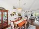 Elegant dining room with a large table, chandelier, and hardwood floors at 18845 Fairway Green Dr, Hudson, FL 34667