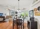 Cozy dining area featuring a dark wood table, elegant lighting, and a view into the bright and spacious living area at 18845 Fairway Green Dr, Hudson, FL 34667