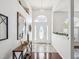 Bright foyer with tile flooring and a decorative console table at 18845 Fairway Green Dr, Hudson, FL 34667