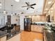 Bright kitchen featuring dark countertops, light wood cabinets, and stainless steel appliances at 18845 Fairway Green Dr, Hudson, FL 34667