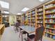 Bright library with extensive bookshelves and tables for reading at 18845 Fairway Green Dr, Hudson, FL 34667