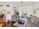Cozy living room with comfortable seating, a glass coffee table and view of the backyard at 18845 Fairway Green Dr, Hudson, FL 34667