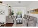 Cozy living room with comfortable seating, a glass coffee table and view of the backyard at 18845 Fairway Green Dr, Hudson, FL 34667