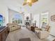 Living room with large windows, fireplace, and multiple seating options, perfect for relaxing and entertaining at 18845 Fairway Green Dr, Hudson, FL 34667