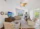 Bright living room featuring a fireplace, large window, and comfortable seating arrangement at 18845 Fairway Green Dr, Hudson, FL 34667