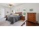 Bright main bedroom with neutral walls, ceiling fan, and wood furnishings at 18845 Fairway Green Dr, Hudson, FL 34667