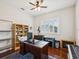 Home office featuring wood floors, window with shutters, and built-in bookcase at 18845 Fairway Green Dr, Hudson, FL 34667