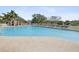 A long outdoor swimming pool surrounded by lounge chairs and a cabana at 18845 Fairway Green Dr, Hudson, FL 34667