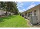 Side view of the property highlighting the grass and backyard on a sunny day at 2165 Springmeadow Dr, Spring Hill, FL 34606
