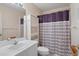Bathroom featuring sink and vanity, toilet, and shower with patterned shower curtain at 2165 Springmeadow Dr, Spring Hill, FL 34606