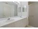 Bright bathroom featuring double sinks, a vanity mirror, and a glass enclosed shower at 2165 Springmeadow Dr, Spring Hill, FL 34606