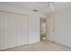 A simple yet spacious bedroom with closet space and a view to the kitchen at 2165 Springmeadow Dr, Spring Hill, FL 34606