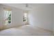 A simple yet spacious bedroom with windows and a ceiling fan at 2165 Springmeadow Dr, Spring Hill, FL 34606