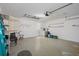 Spacious garage area featuring painted walls, shelving, speckled floor, and access to laundry at 2165 Springmeadow Dr, Spring Hill, FL 34606