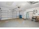 Spacious garage with ample storage, a door to the exterior, and a garage door at 2165 Springmeadow Dr, Spring Hill, FL 34606